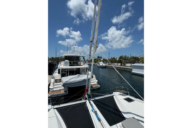  Yacht Photos Pics Lagoon 46 catamaran docked in a marina, clear blue sky, 2020 model.