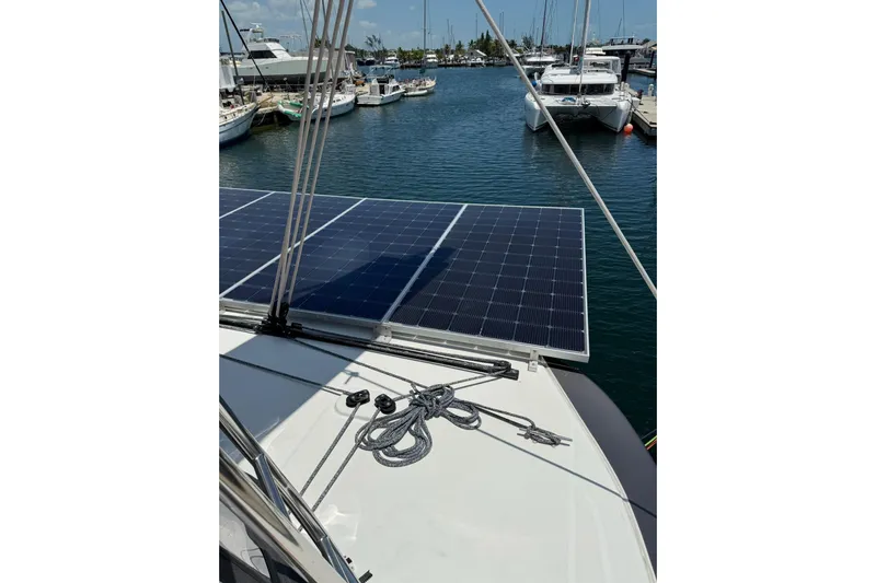  Yacht Photos Pics Lagoon 46 catamaran (2020) with solar panels docked in a marina.