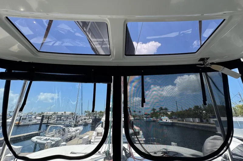  Yacht Photos Pics Interior view from a 2020 Lagoon 46 catamaran, showcasing marina and sky through windows.