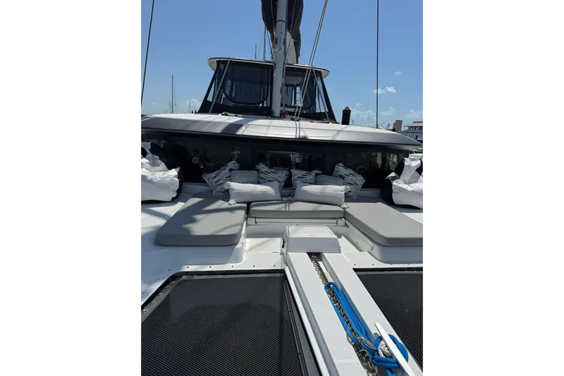  Yacht Photos Pics 2020 Lagoon 46 yacht with cushioned deck and sleek design.