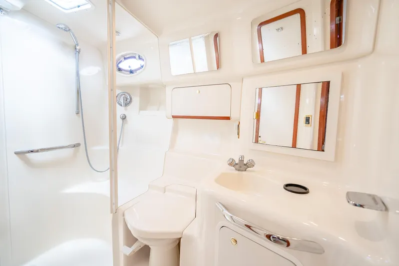 Knot Ez II Yacht Photos Pics Luxurious bathroom in 1998 Sea Ray 450 Sundancer yacht with shower and sink.