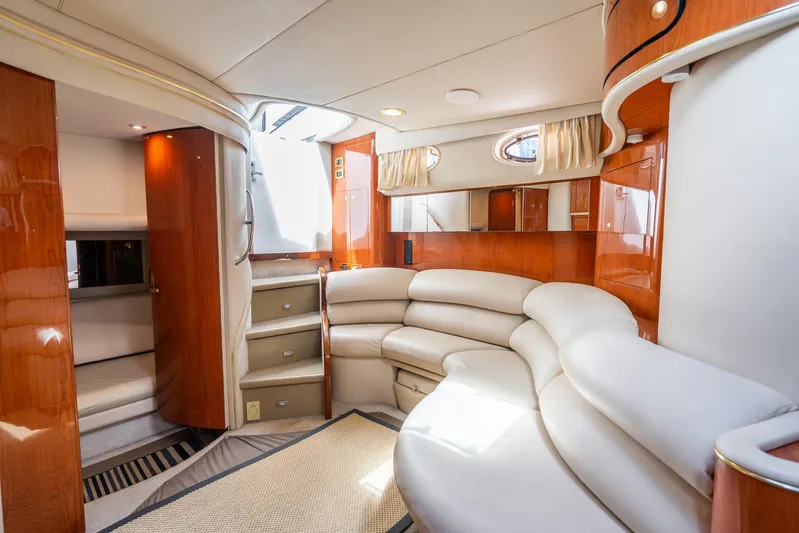 Knot Ez II Yacht Photos Pics Luxurious interior of a 1998 Sea Ray 450 Sundancer yacht with plush seating and wood accents.