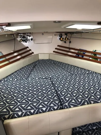  Yacht Photos Pics 2007 Grady-White Express 330 cabin interior with patterned bedding and fishing rods.