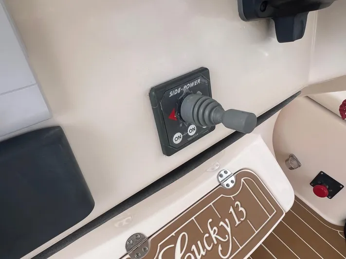  Yacht Photos Pics Control panel of a 2007 Grady-White Express 330 boat with joystick and "Lucky 13" label.