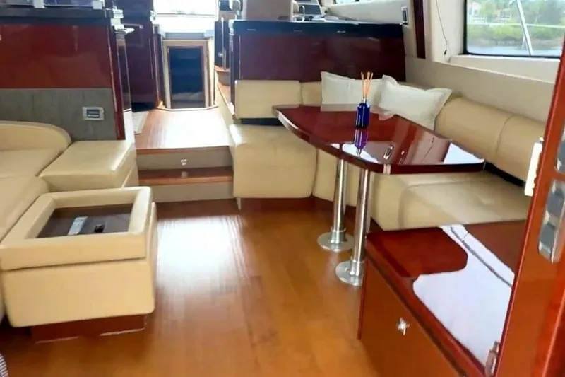 Caroline Kai Yacht Photos Pics Luxurious interior of 2016 Sea Ray 510 Fly yacht with elegant seating and polished wood finishes.