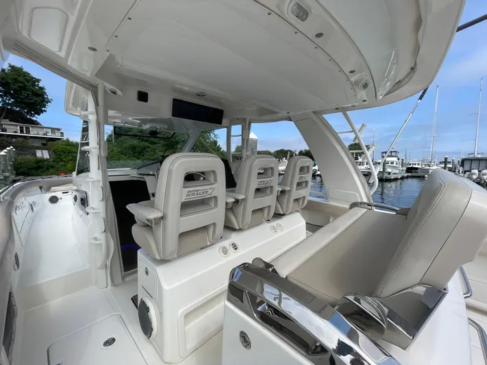  Yacht Photos Pics 2017 Boston Whaler 420 Outrage interior with seating and helm, docked at marina.