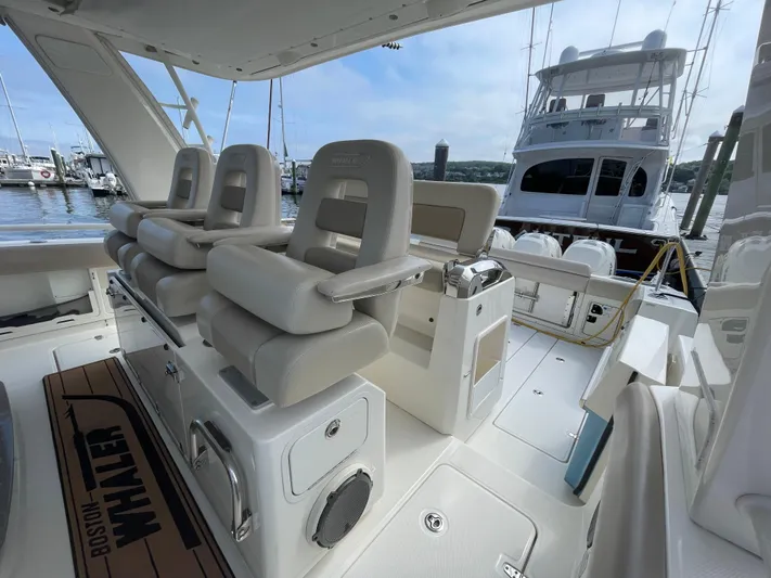  Yacht Photos Pics 2017 Boston Whaler 420 Outrage interior with luxurious seating and marina view.