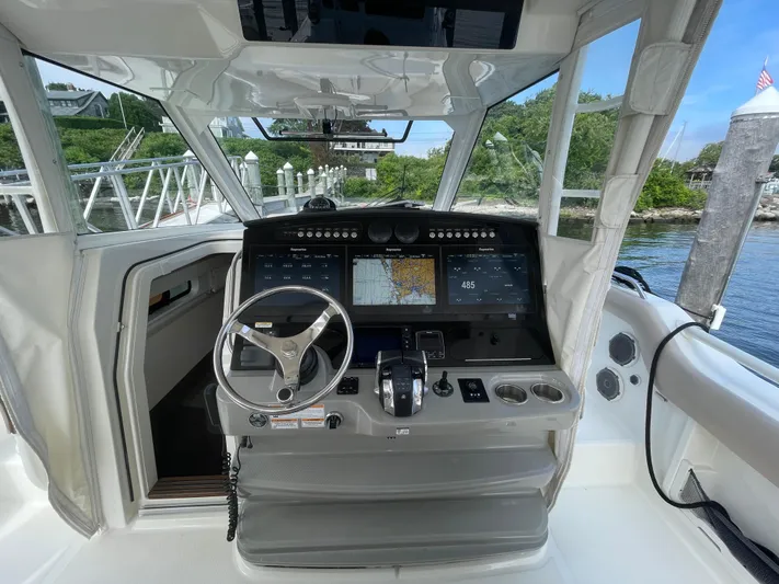  Yacht Photos Pics 2017 Boston Whaler 420 Outrage helm with advanced navigation displays and steering wheel.