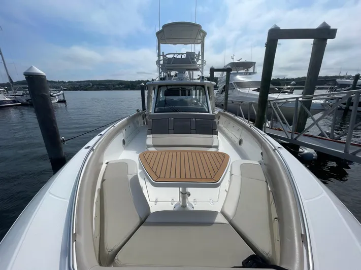  Yacht Photos Pics 2017 Boston Whaler 420 Outrage docked, showcasing spacious deck and seating area.