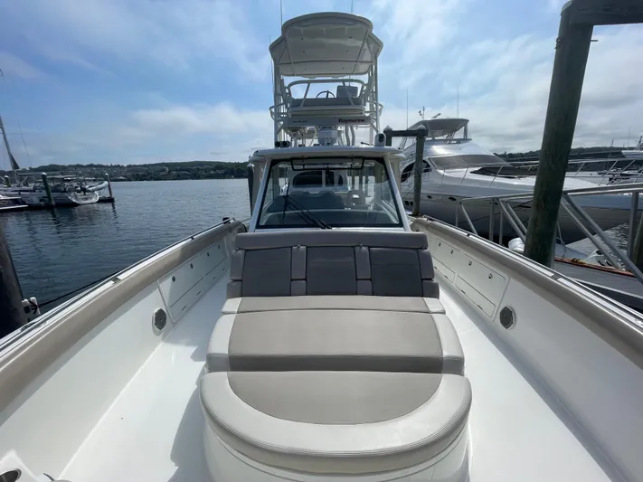  Yacht Photos Pics 2017 Boston Whaler 420 Outrage boat docked at marina, featuring spacious seating and clear skies.