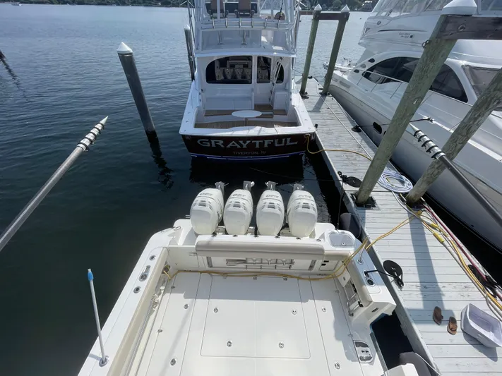  Yacht Photos Pics 2017 Boston Whaler 420 Outrage docked, featuring powerful outboard engines and spacious deck.