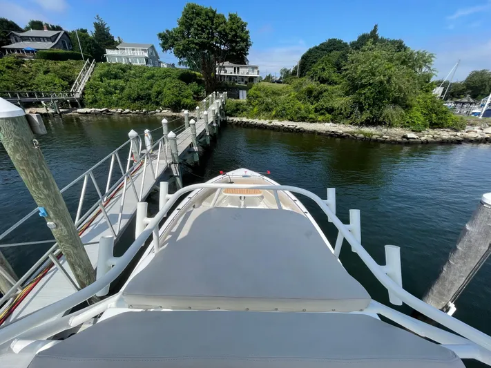  Yacht Photos Pics Boston Whaler 420 Outrage 2017 docked at a scenic waterfront location.