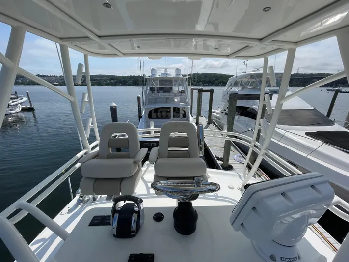  Yacht Photos Pics Boston Whaler 420 Outrage 2017 helm view, docked with other boats in marina.
