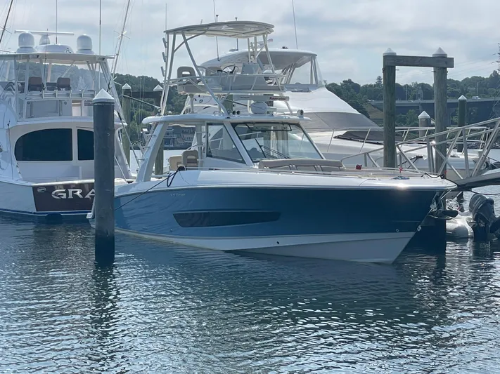  Yacht Photos Pics 2017 Boston Whaler 420 Outrage docked at marina, surrounded by other boats.