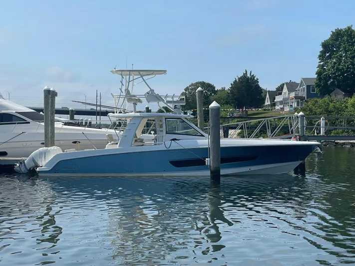  Yacht Photos Pics 2017 Boston Whaler 420 Outrage docked in a marina, surrounded by calm water.