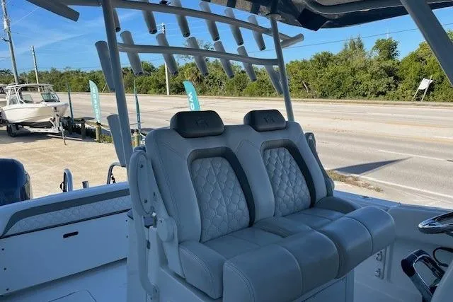  Yacht Photos Pics 2020 World Cat 280 CC-X boat with luxurious seating and rod holders, parked near a road.