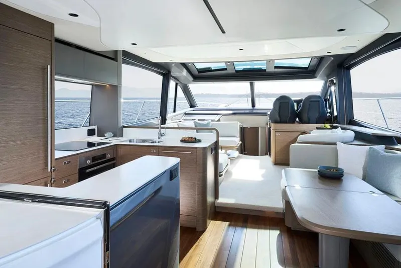 Yacht Photos Pics Manufacturer Provided Image: Luxurious interior of 2025 Princess S65 yacht with modern kitchen and seating area.