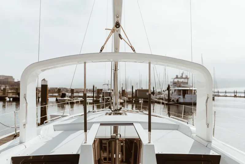  Yacht Photos Pics 2024 Beneteau Oceanis 51.1 yacht docked at a marina, showcasing sleek design and modern features.