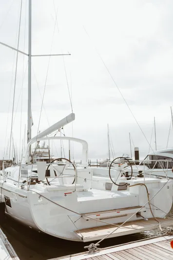  Yacht Photos Pics 2024 Beneteau Oceanis 51.1 yacht docked at marina, rear view.