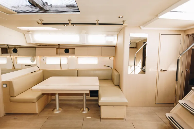  Yacht Photos Pics Luxurious interior of 2024 Beneteau Oceanis 51.1 yacht with modern seating and dining area.