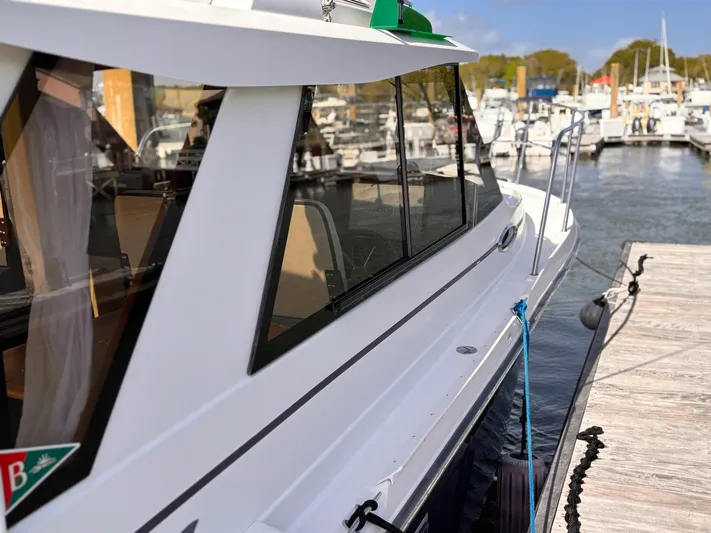 Seahorse Yacht Photos Pics 2016 Cutwater 28 LE boat docked at marina, side view with clear windows.