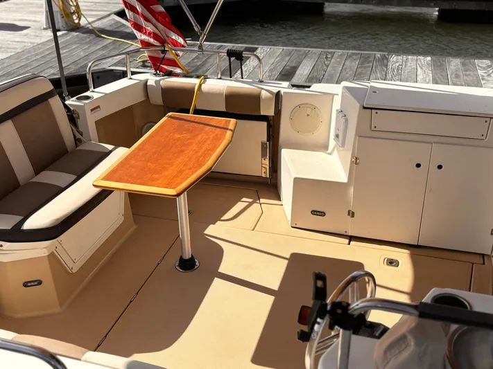 Seahorse Yacht Photos Pics 2016 Cutwater 28 LE boat interior with seating, table, and storage compartments.
