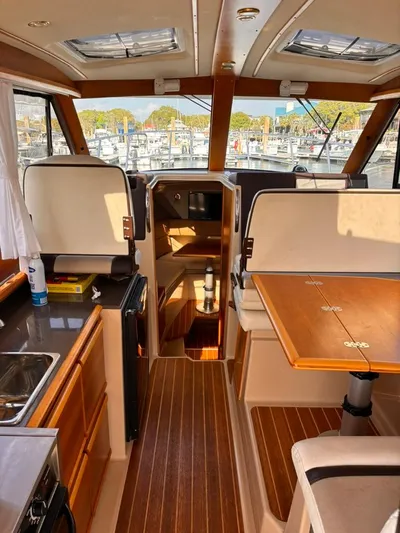 Seahorse Yacht Photos Pics Interior of a 2016 Cutwater 28 LE boat with wood accents and seating.