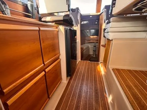Seahorse Yacht Photos Pics Interior of 2016 Cutwater 28 LE boat with wooden cabinetry and flooring.