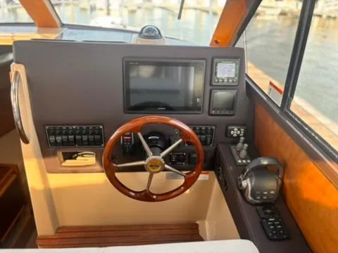 Seahorse Yacht Photos Pics Helm of 2016 Cutwater 28 LE boat with wooden steering wheel and navigation controls.