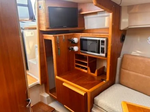 Seahorse Yacht Photos Pics Interior of 2016 Cutwater 28 LE boat with TV, microwave, and seating area.