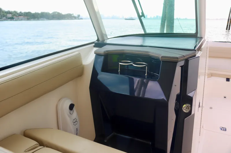  Yacht Photos Pics 2017 Pursuit DC 295 Dual Console interior with seating and storage, overlooking water.