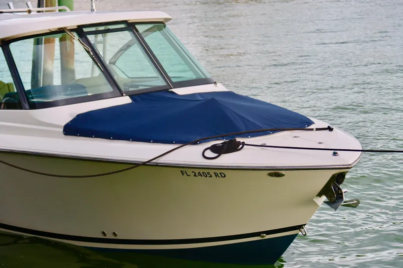  Yacht Photos Pics 2017 Pursuit DC 295 Dual Console boat docked on calm water.