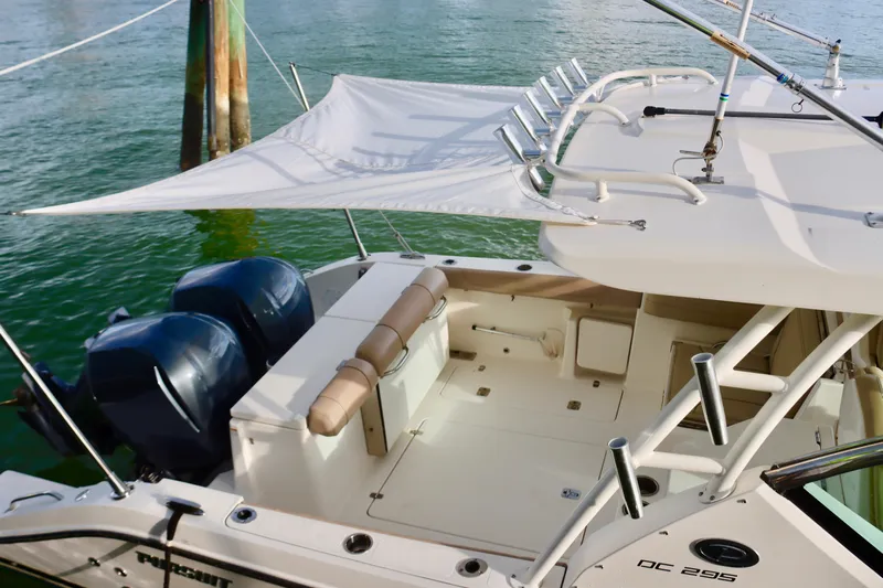  Yacht Photos Pics 2017 Pursuit DC 295 Dual Console boat with twin engines and sunshade on water.