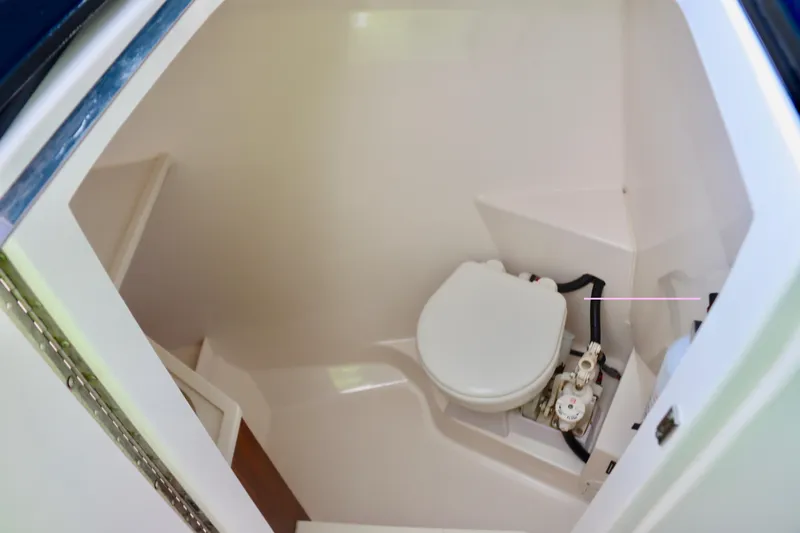  Yacht Photos Pics 2017 Pursuit DC 295 Dual Console boat interior with compact marine toilet.