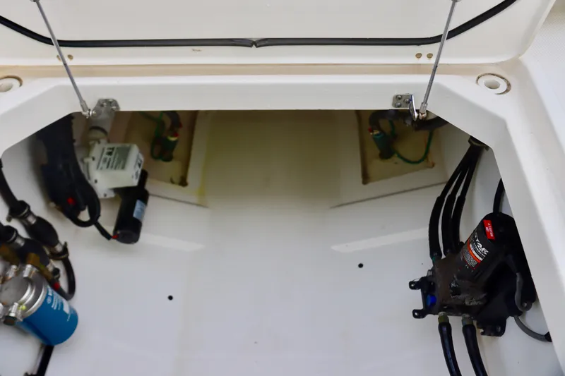  Yacht Photos Pics 2017 Pursuit DC 295 Dual Console boat interior, showcasing storage and mechanical components.