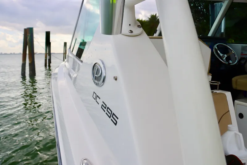  Yacht Photos Pics 2017 Pursuit DC 295 Dual Console boat on water, side view.