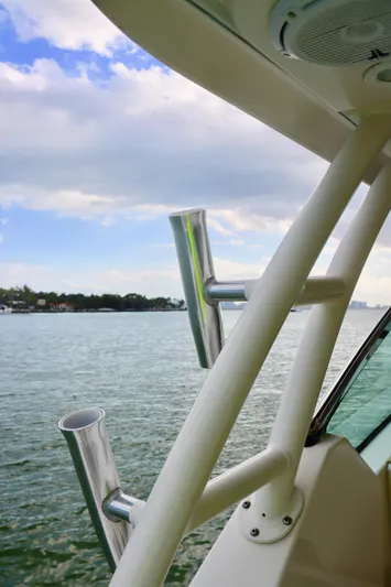  Yacht Photos Pics 2017 Pursuit DC 295 Dual Console boat with rod holders, scenic water view.