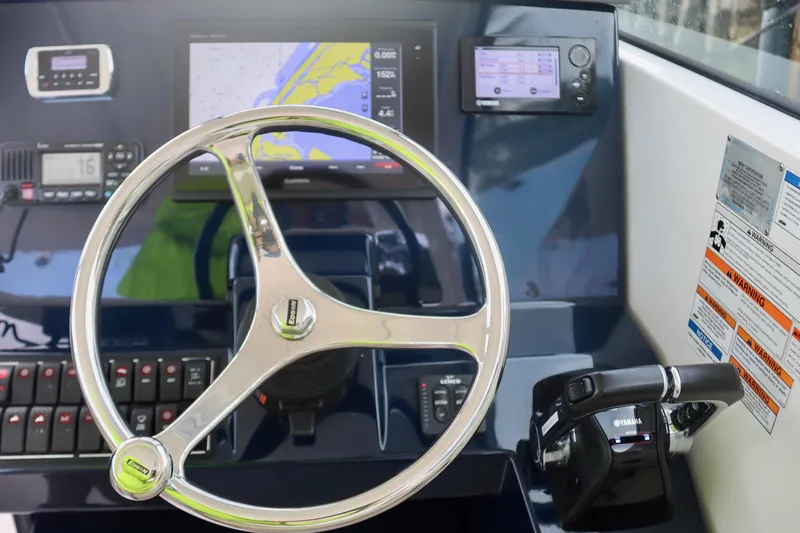  Yacht Photos Pics 2017 Pursuit DC 295 Dual Console dashboard with steering wheel and navigation controls.