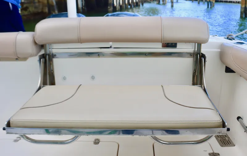  Yacht Photos Pics 2017 Pursuit DC 295 Dual Console boat seat with beige upholstery and stainless steel frame.