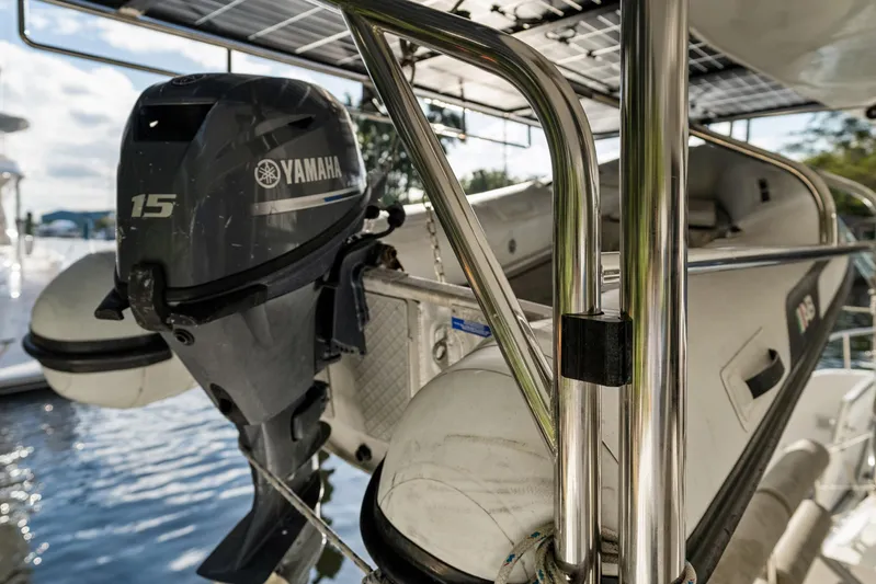 Benedetto Yacht Photos Pics Yamaha 15 outboard motor on 2020 Lagoon 42 catamaran, docked by the water.