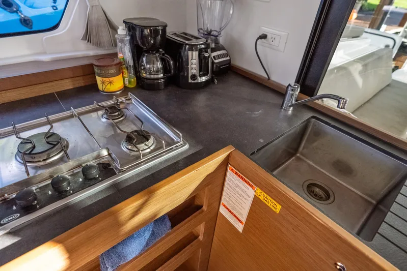 Benedetto Yacht Photos Pics Modern kitchen in 2020 Lagoon 42 yacht with stove, sink, and appliances.