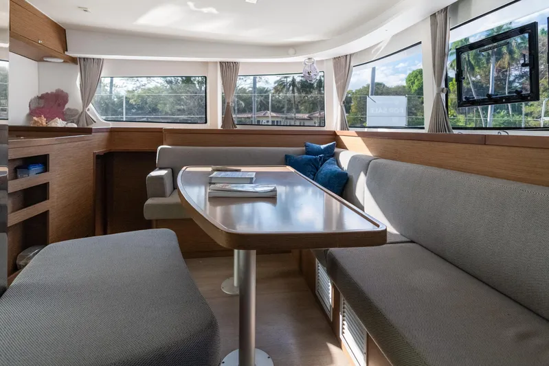 Benedetto Yacht Photos Pics Luxurious interior of 2020 Lagoon 42 catamaran with modern seating and large windows.