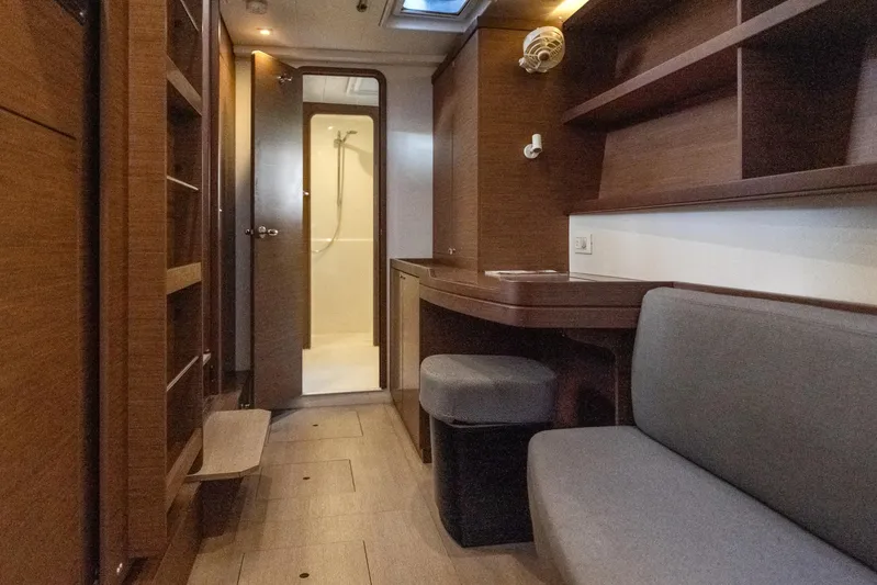 Benedetto Yacht Photos Pics Interior of 2020 Lagoon 42 yacht, featuring wood finish, seating, and bathroom access.