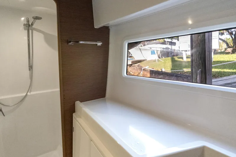Benedetto Yacht Photos Pics Interior of 2020 Lagoon 42 yacht bathroom with shower and window view.