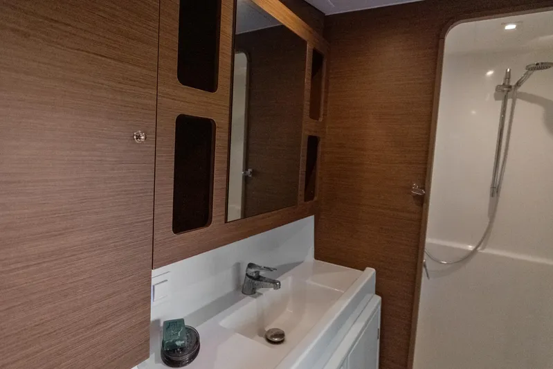 Benedetto Yacht Photos Pics Modern bathroom interior of 2020 Lagoon 42 yacht with wood accents and shower.