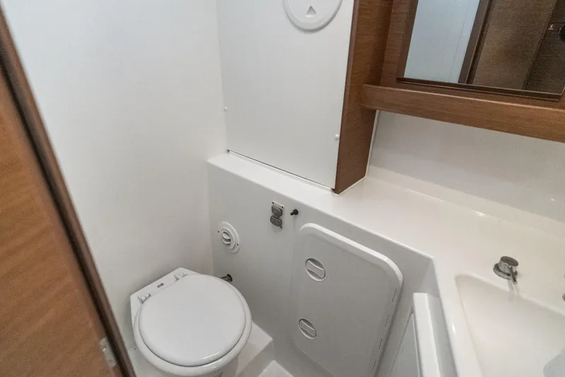 Benedetto Yacht Photos Pics 2020 Lagoon 42 yacht bathroom with modern fixtures and wooden accents.