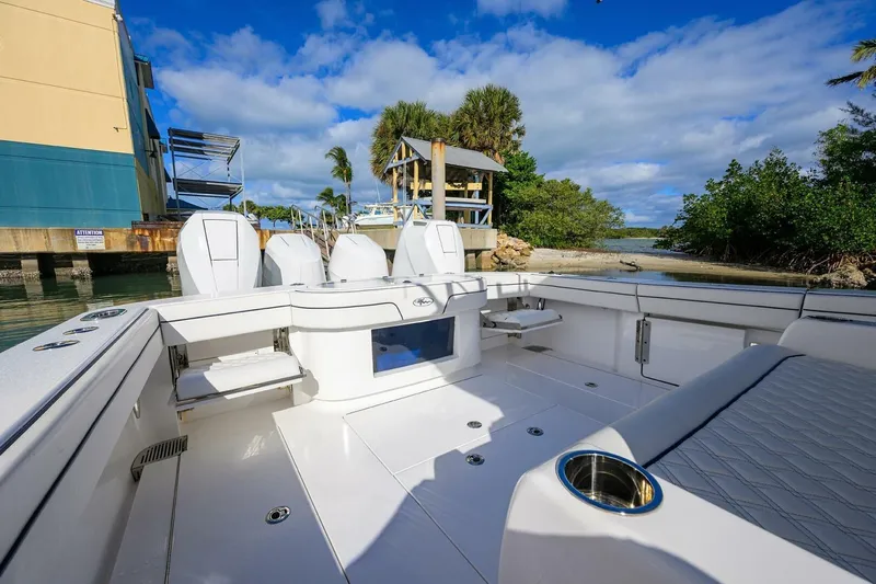 Fishability Yacht Photos Pics 2025 Valhalla Boatworks V-41, spacious deck, docked near lush greenery and blue skies.