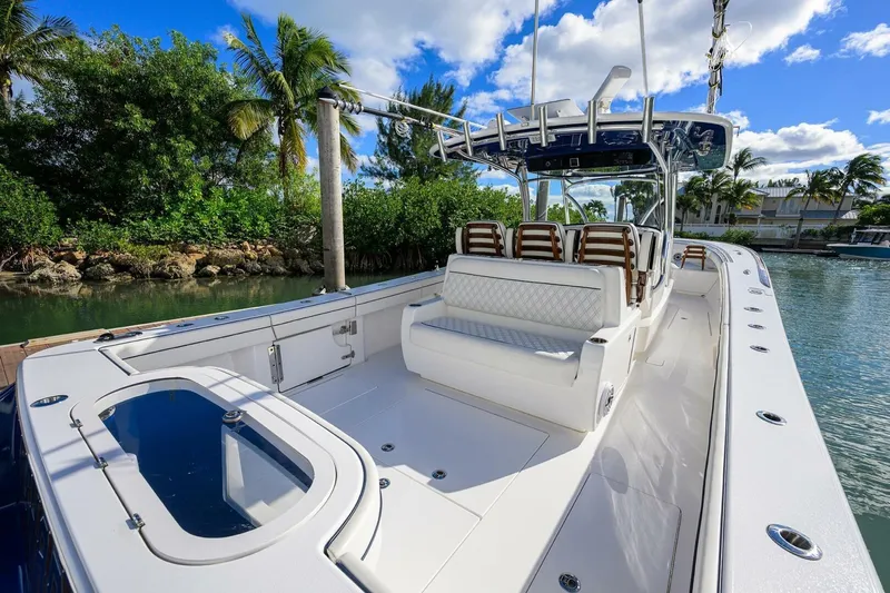 Fishability Yacht Photos Pics 2025 Valhalla Boatworks V-41, sleek design, spacious deck, luxury seating, tropical backdrop.