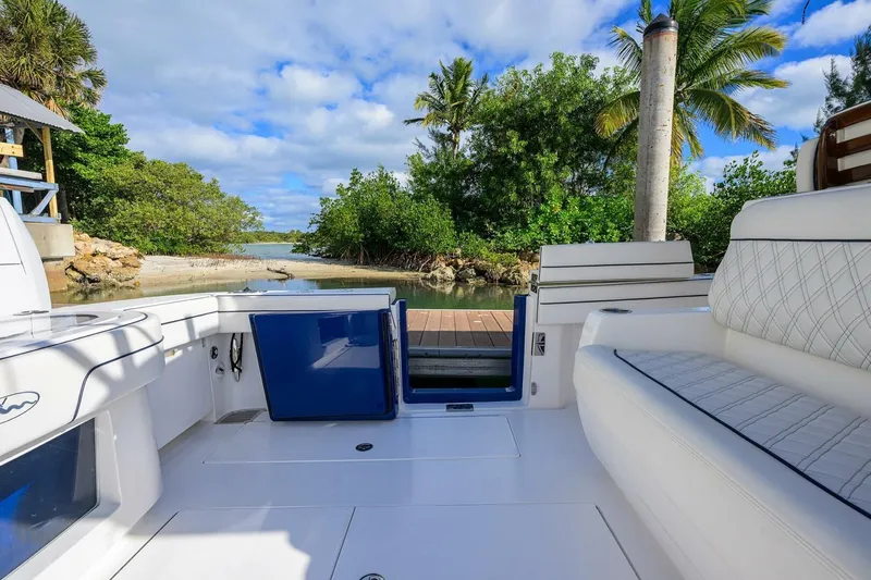 Fishability Yacht Photos Pics 2025 Valhalla Boatworks V-41 interior with luxurious seating, dockside view, and tropical backdrop.