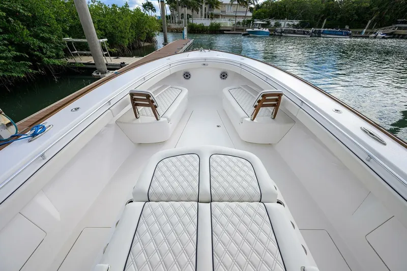 Fishability Yacht Photos Pics 2025 Valhalla Boatworks V-41 with luxurious seating, docked by lush greenery.